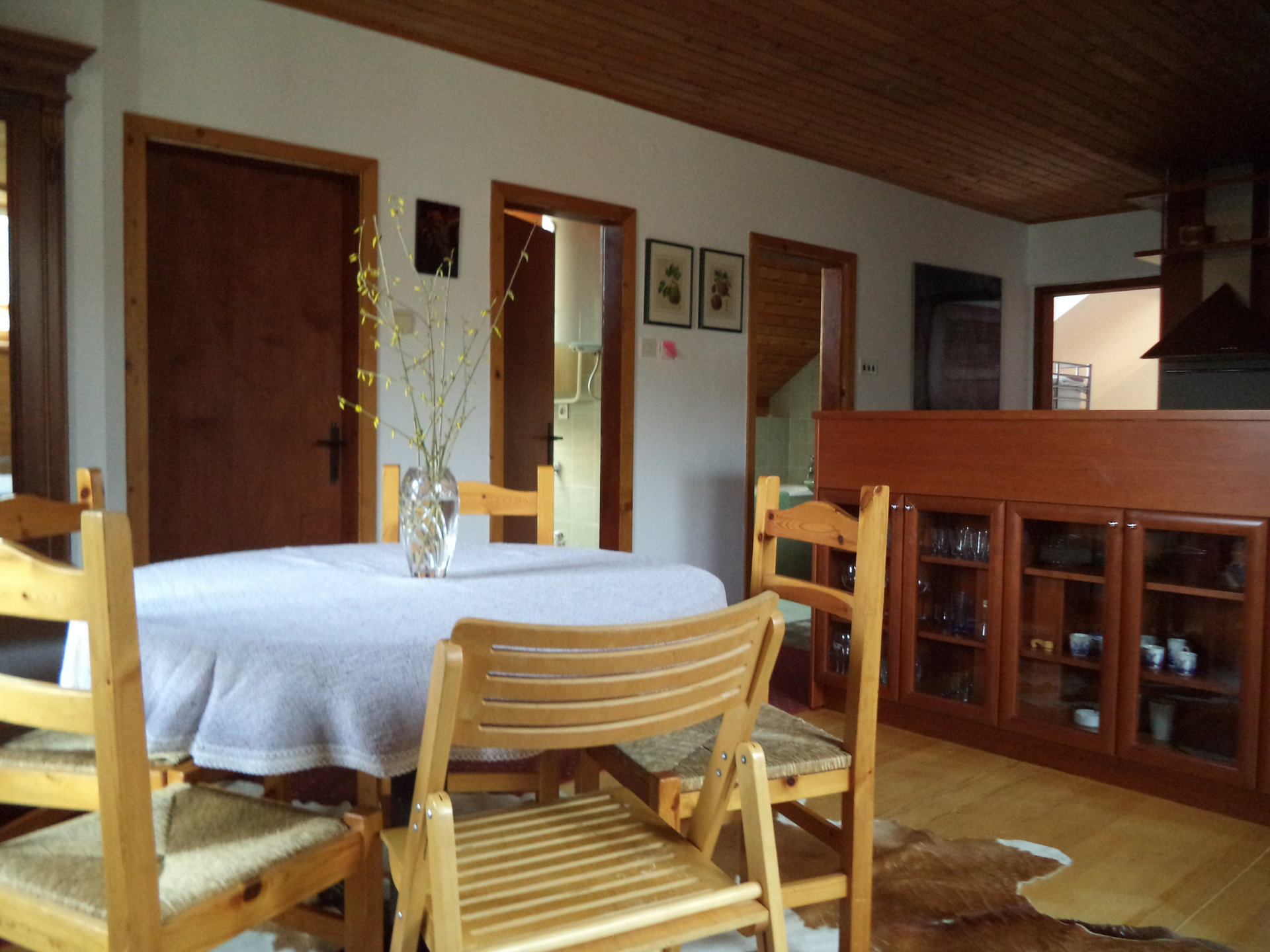 The dining room with kitchen visible in background.